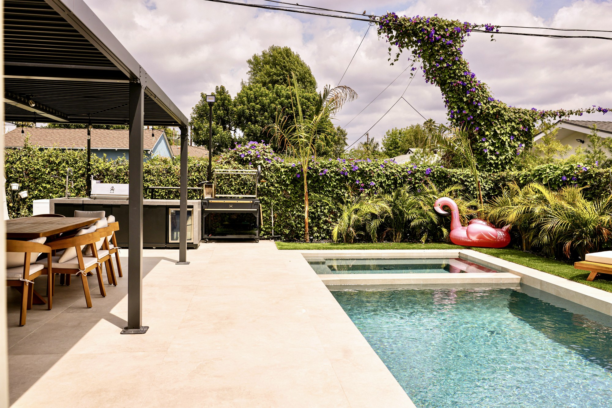 Pool and landscaped grounds under the mature cedar canopy